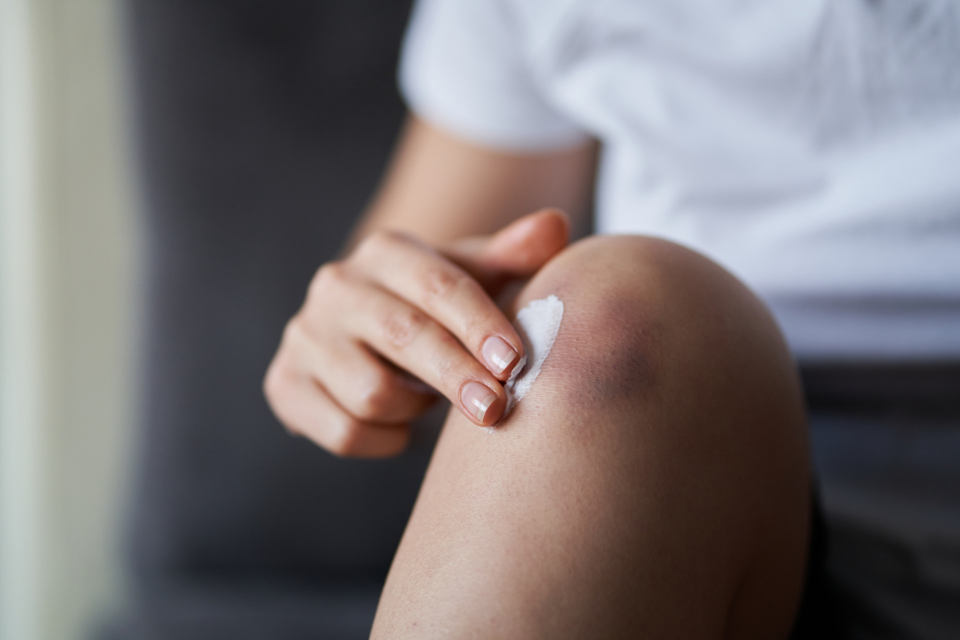 A marijuana-infused topical being rubbed into a person's need