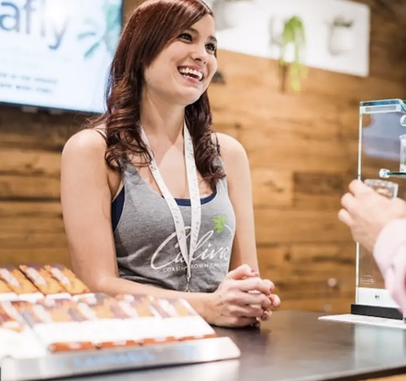 Budtenders help clients in a dispensary to select marijuana