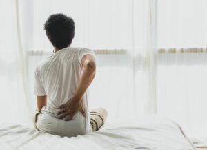 women clutching her back to represent using CBD for Sciatica pain