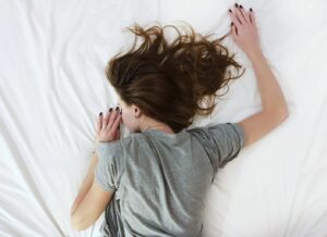 Women lying in bed to illustrate using cannabis during your period