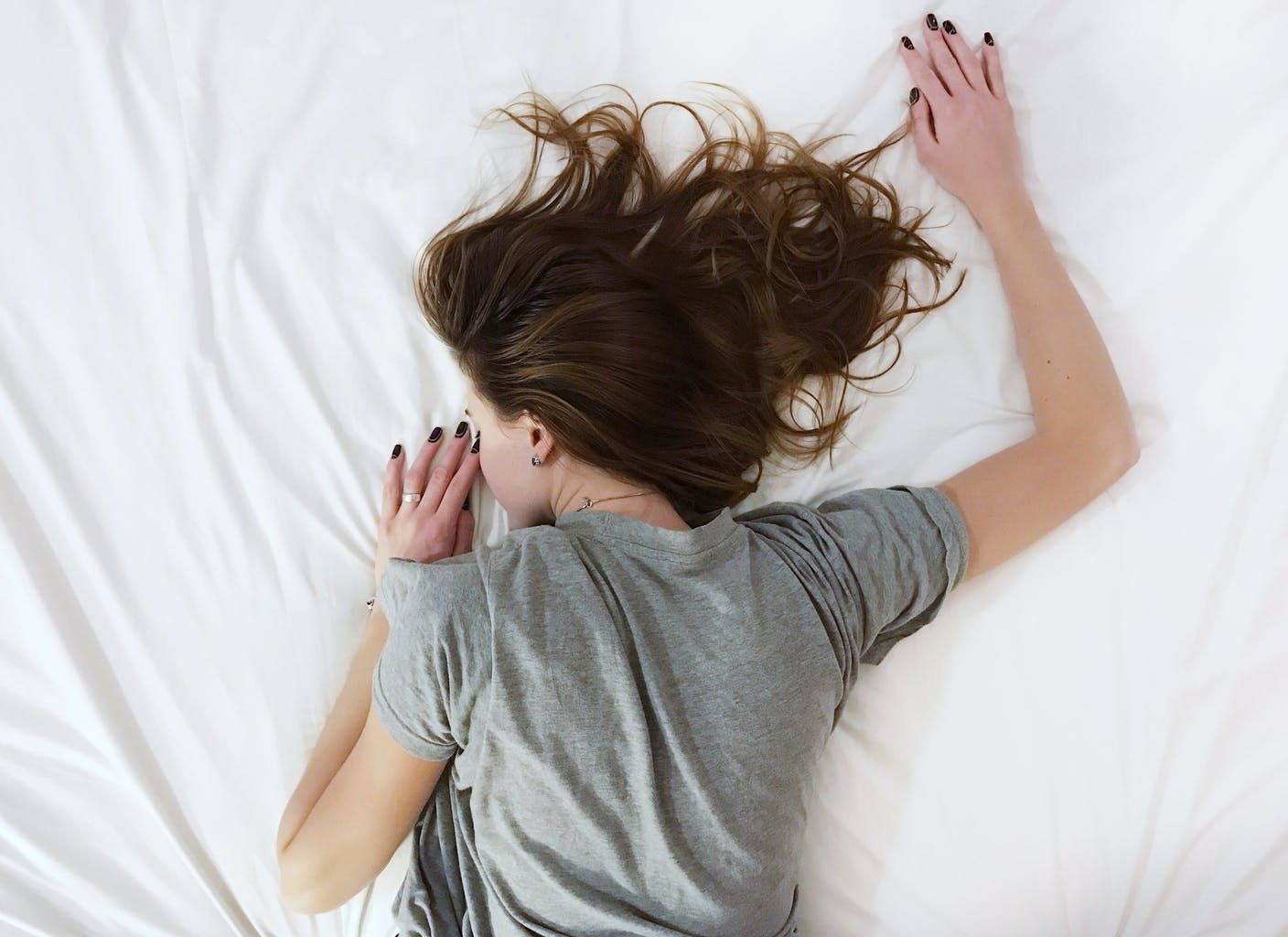 Women lying in bed to illustrate using cannabis during your period